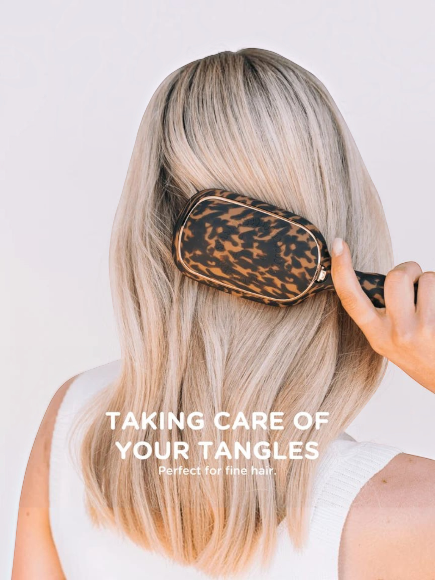 Mialur TELETIES detangler hair brush in tortoise print being used on blonde hair to gently brush through tangles.