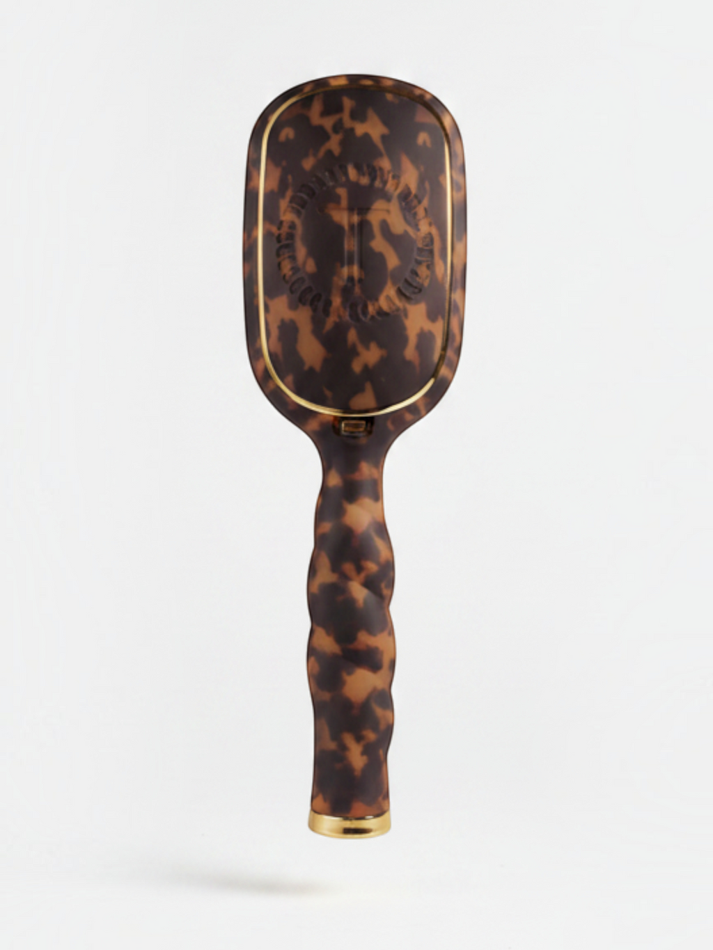 Mialur TELETIES boar bristle hair brush in tortoise pattern with a coil-inspired grip and gold accents.