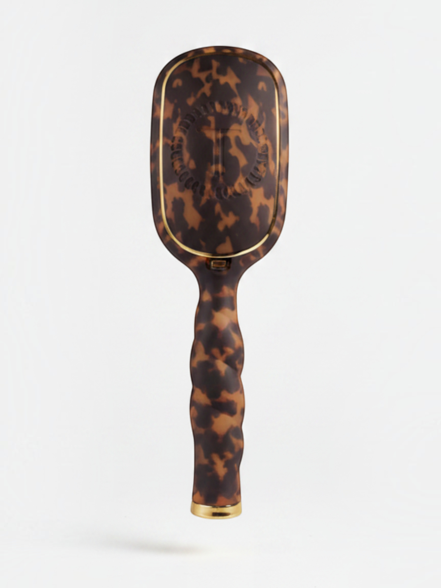 Mialur TELETIES boar bristle hair brush in tortoise pattern with a coil-inspired grip and gold accents.