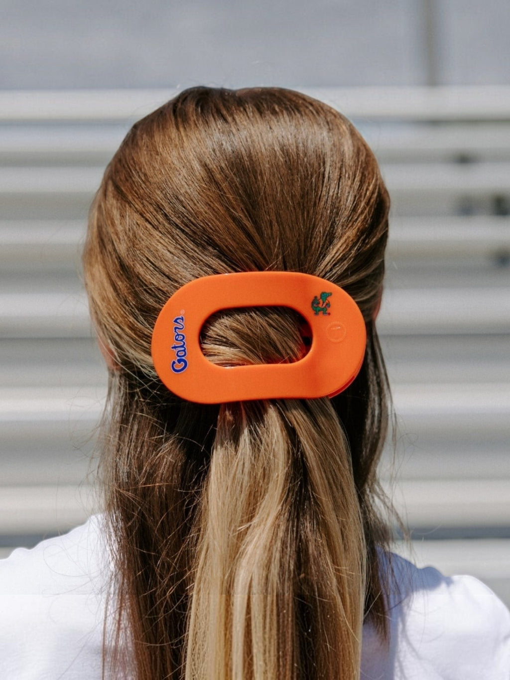 Mialur University of Florida orange and blue flat round hair clip worn in hair for a comfortable secure hold