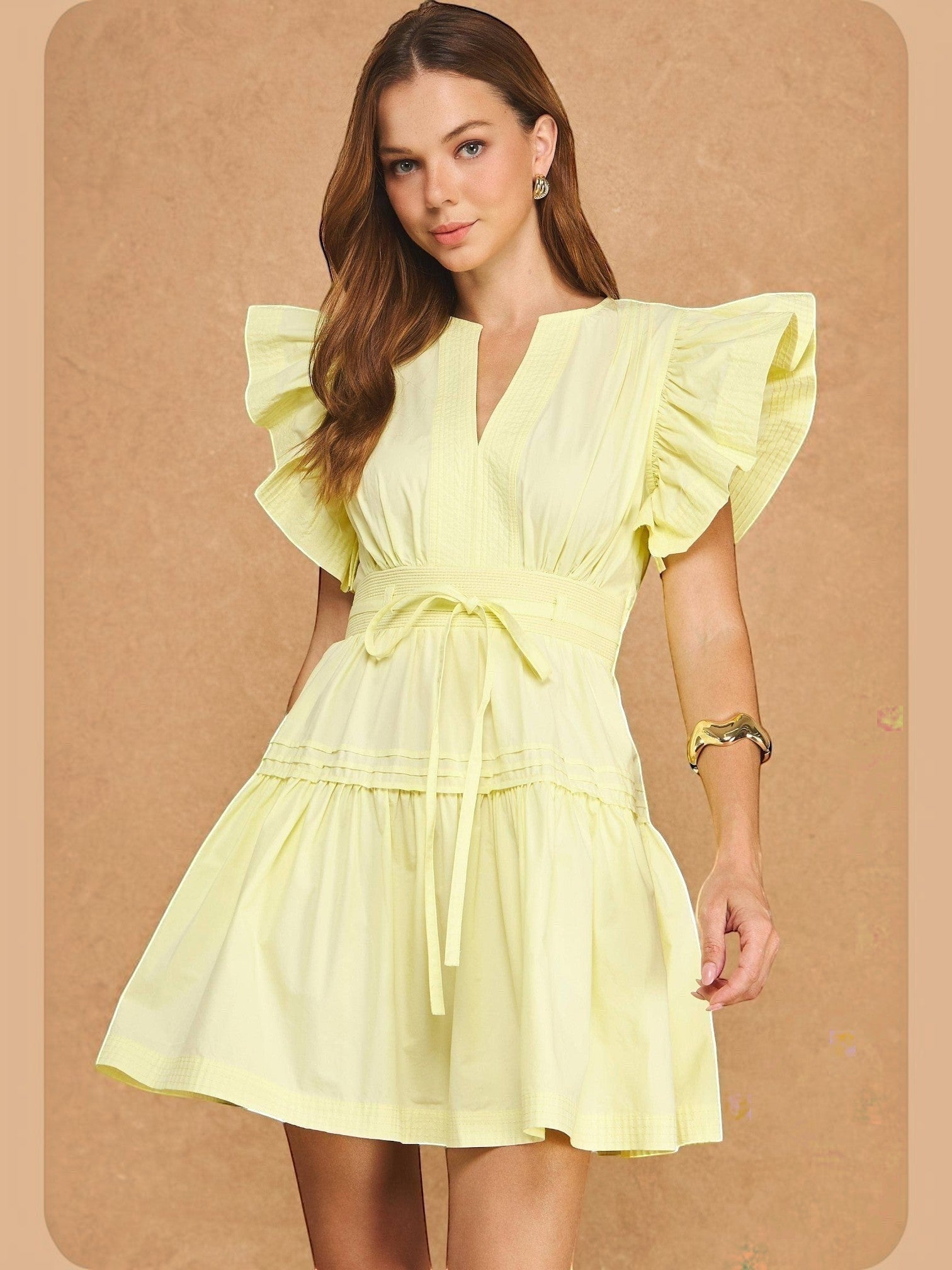 Model wearing Mialur butter yellow Valencia babydoll dress with flutter sleeves, V-neck, and smocked waist.