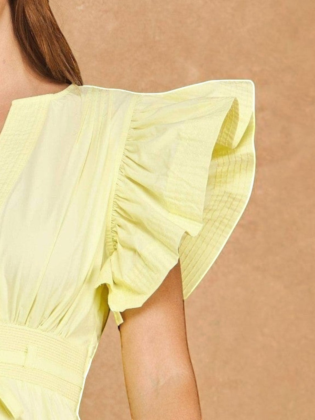 Mialur Valencia dress in butter yellow featuring flutter sleeves, a split V-neckline, and a smocked waist.