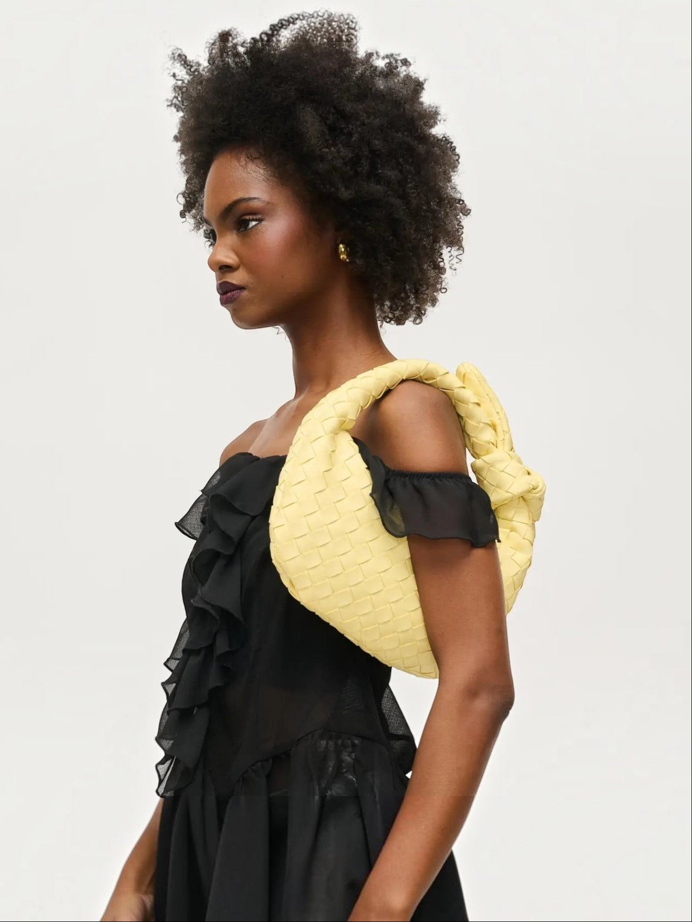 Mialur Verona Bag in butter yellow vegan leather with a woven texture and knot handle carried by a model