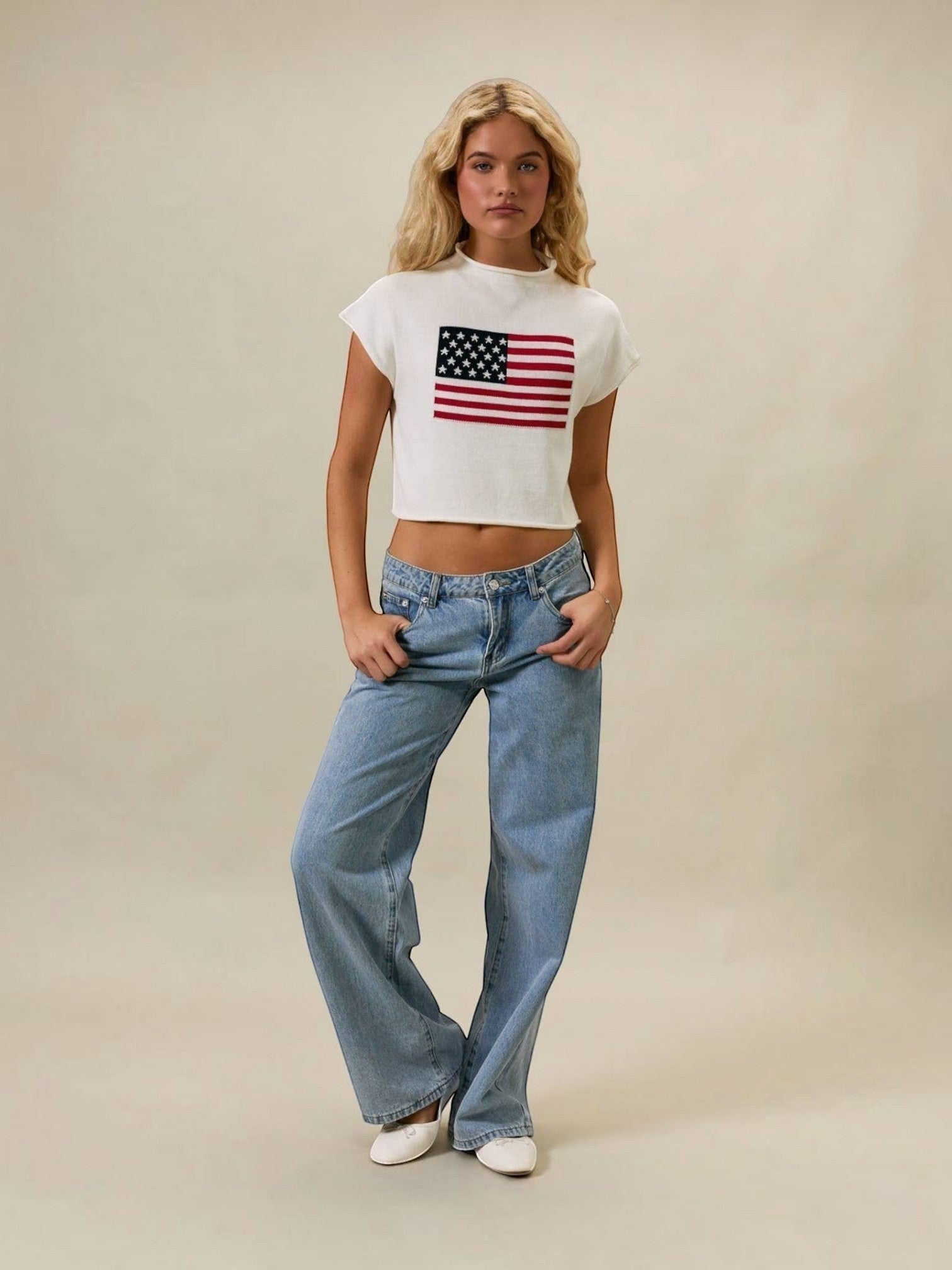 Mialur white mock neck top with American flag graphic, styled with loose blue jeans on a blonde model.