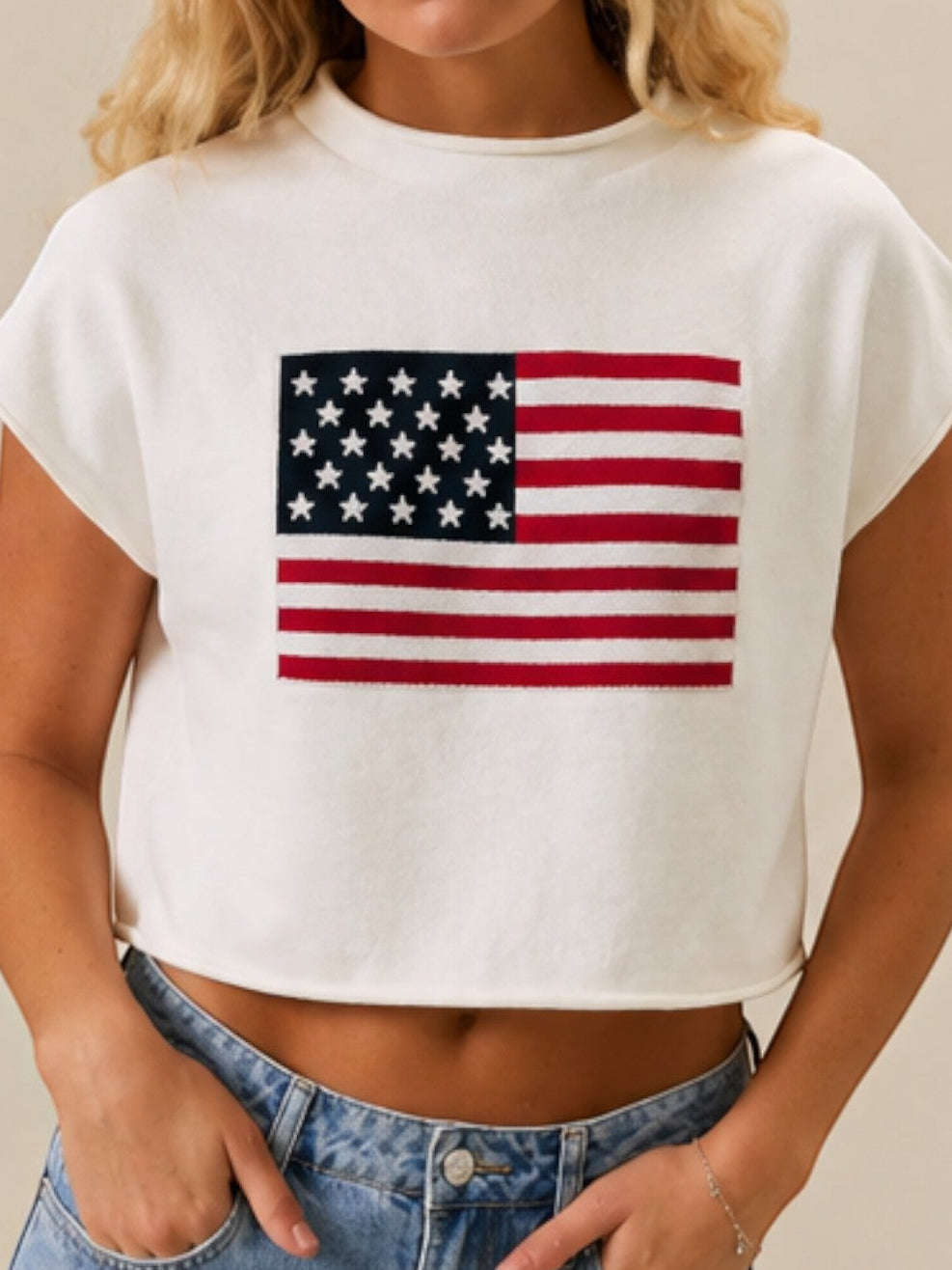 Mialur white mock neck top with American flag graphic and relaxed drop shoulder fit worn by a blonde model