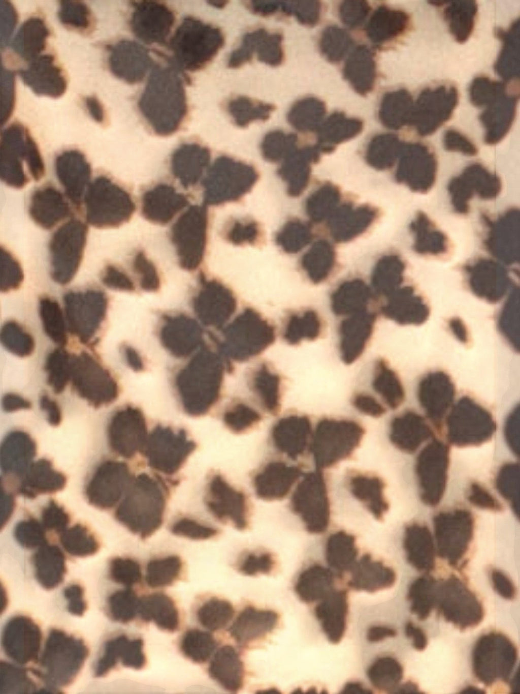 Mialur Wild Muse mini dress fabric featuring a brown and beige animal-inspired floral print on lightweight material.