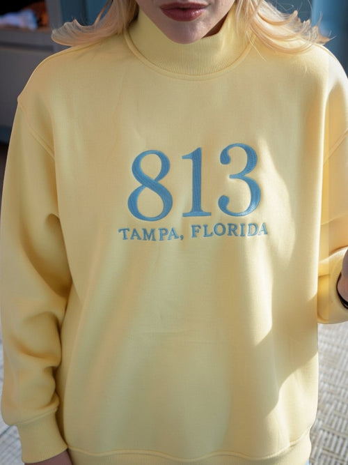 Mialur yellow mock neck sweatshirt featuring blue 813 Tampa Florida collegiate-style embroidery on the chest.