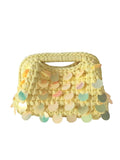 Mialur Tropez yellow woven handbag featuring shimmering iridescent paillette sequins for a glamorous summer look.